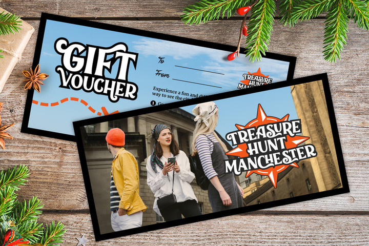 A gift voucher for Treasure Hunt Manchester on a table covered with Christmas decorations