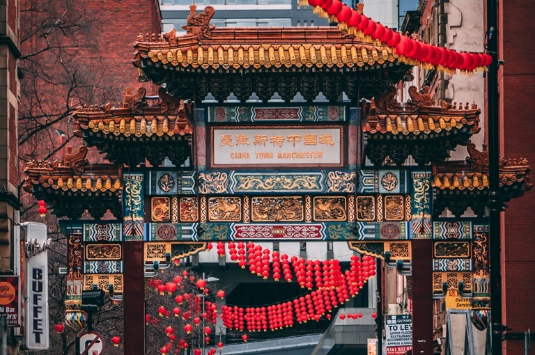 Manchester's hugh Imperial China Arch adorned with phoenixes and dragons.