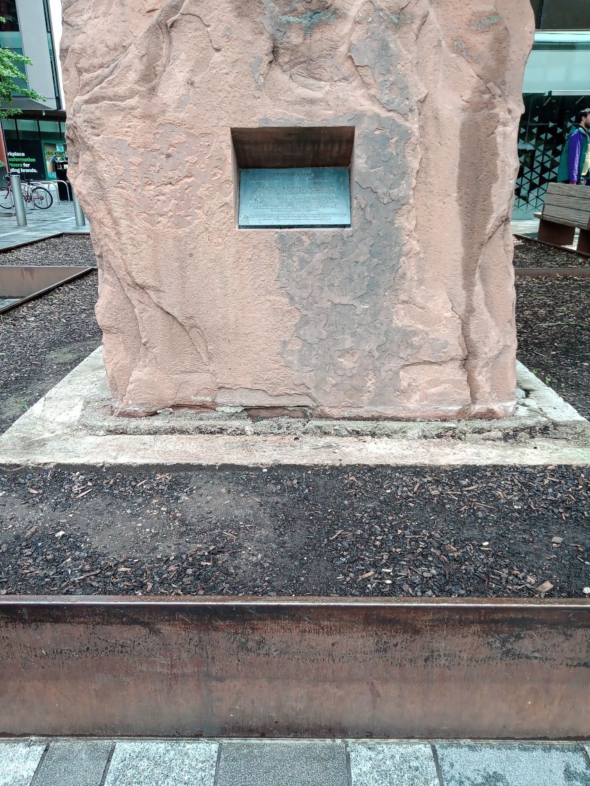 A small sign on the side of a raised plinth