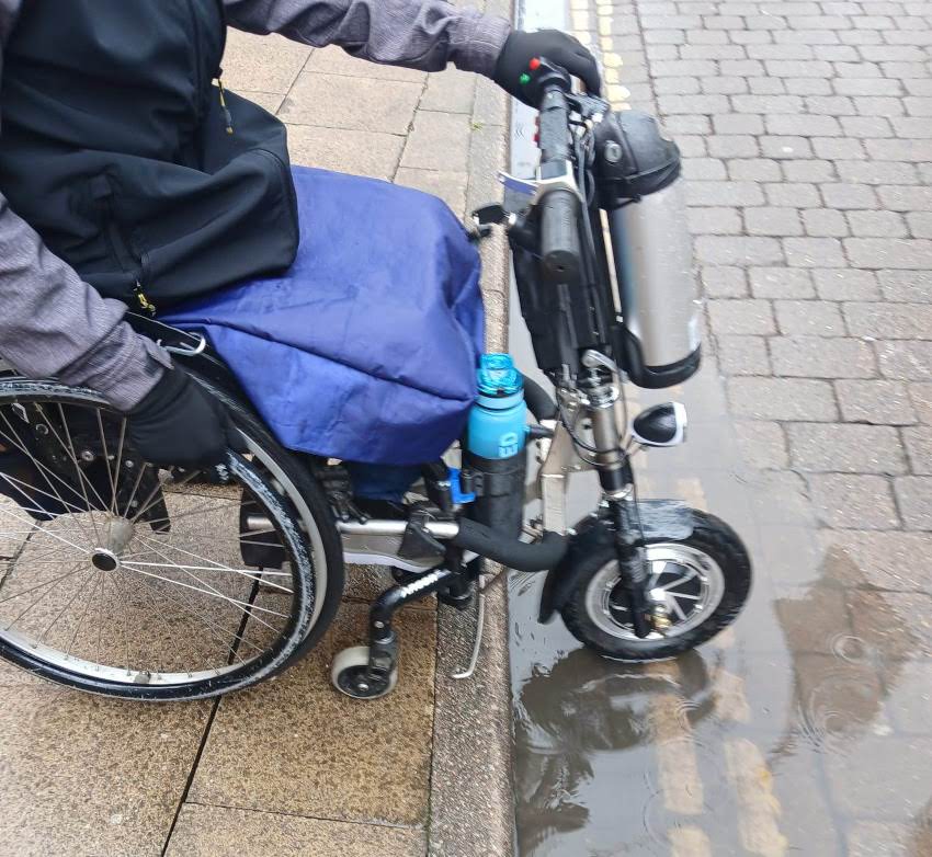 Wheelchair with powered front wheel